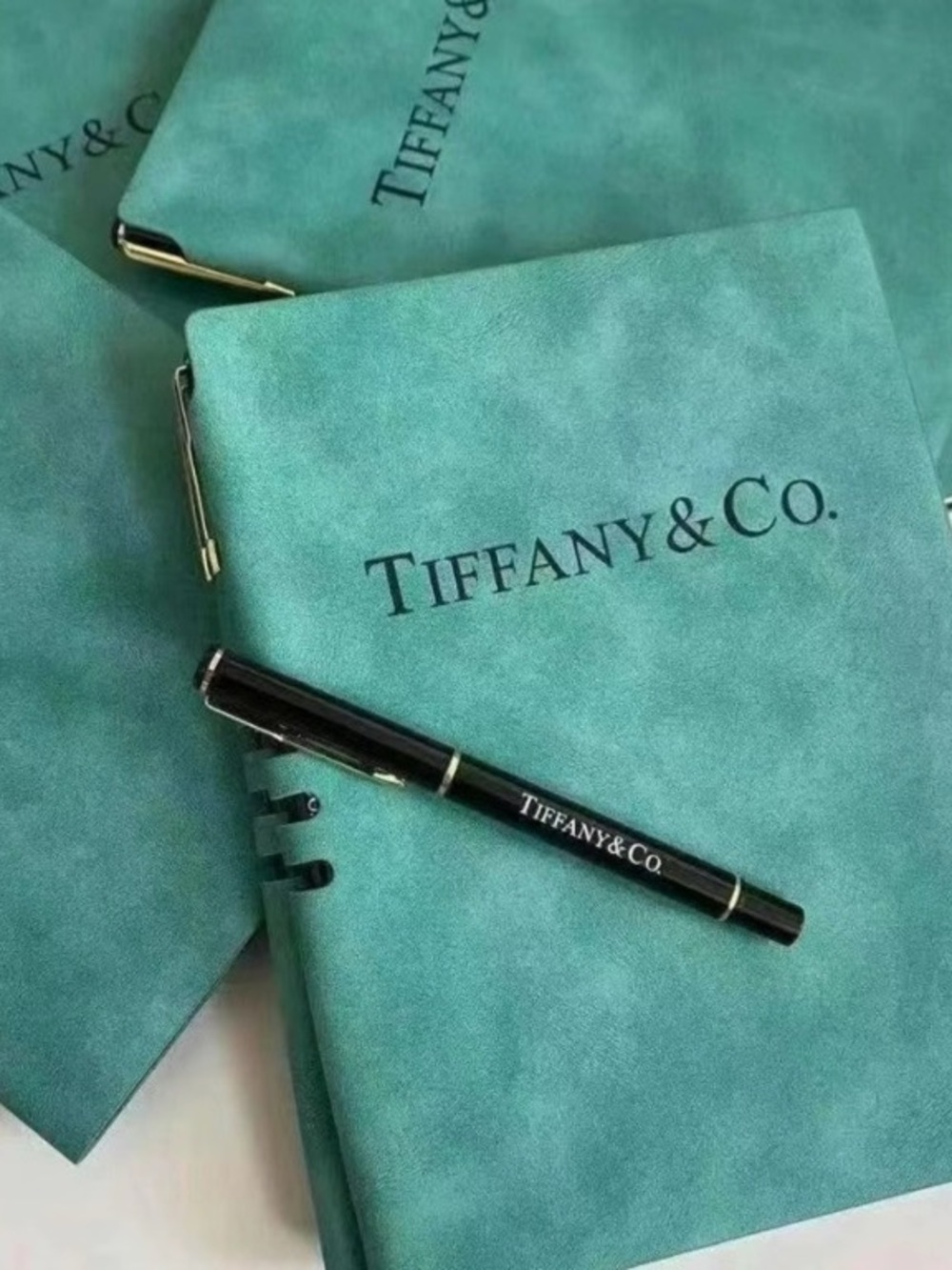 Tiffany & Co. teal notebooks with black branded pen
